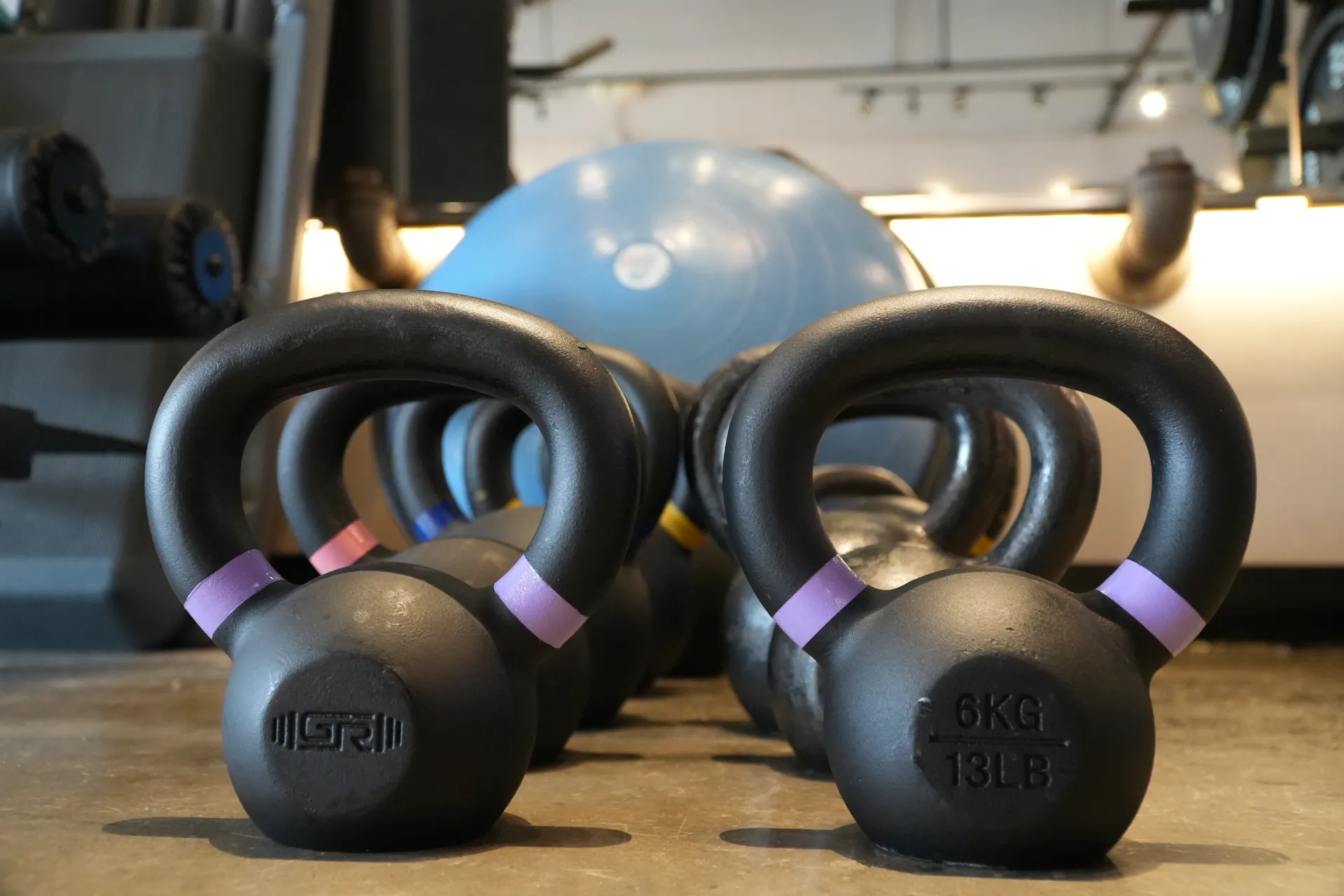 Kettlebells racked on the floor at the ZERO studio